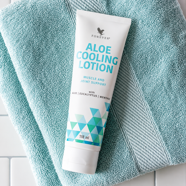 Forever Aloe Cooling Lotion 118 ml posée sur une serviette de bain dans un décor spa apaisant